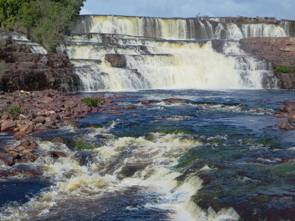 How to Reach Orinduik Falls For the ultimate adventure, you can travel to Orinduik Falls by taking a chartered flight from Georgetown or Lethem. Many Guyana travel packages offer convenient flights that include aerial views of the Pakaraima Highlands and other scenic landmarks. The journey itself becomes a memorable experience as you traverse Guyana’s lush rainforest, which is also home to rare wildlife species. You can explore more about Guyana's eco-tourism in this guide. Alternatively, an overland journey through Lethem allows you to immerse yourself in the heart of Guyana’s cultural and ecological diversity. This route passes through Amerindian villages, where you can stop to experience local hospitality and learn about traditional Guyanese lifestyles. This adds a layer of cultural enrichment to your adventure. Why You Should Visit During Guyana’s Festivals For a truly immersive experience, plan your visit to coincide with some of Guyana’s cultural festivals. Celebrations like Mashramani and Phagwah are vibrant expressions of the country's diverse heritage and offer tourists a unique cultural window. For more on these festivals, check out Mashramani: Guyana's Colorful Celebration of Unity and Culture or Phagwah: A Burst of Color and Culture.